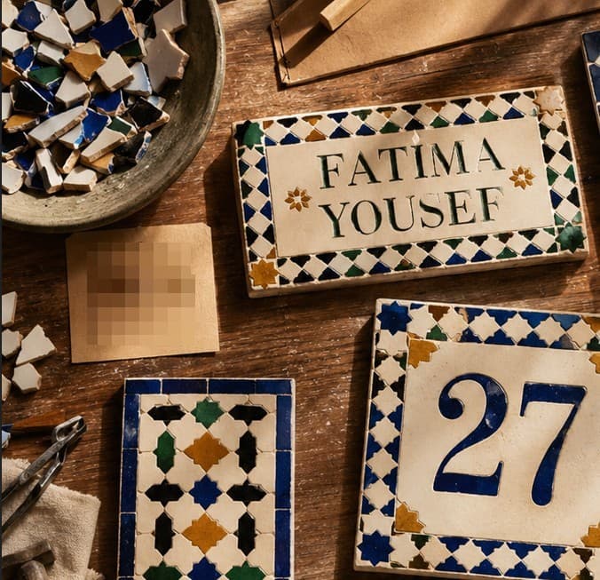 Zellij name panel reading Fatima Yousef with a geometric star border in green, blue and saffron, displayed alongside a number 27 panel.
